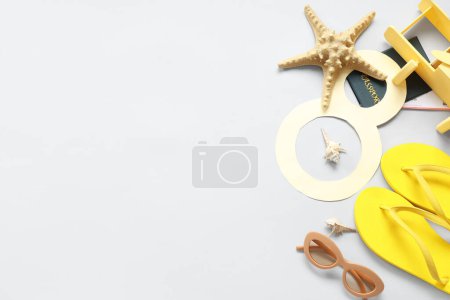 Composition with paper figure 8, beach accessories and starfish on light background. International Women's Day