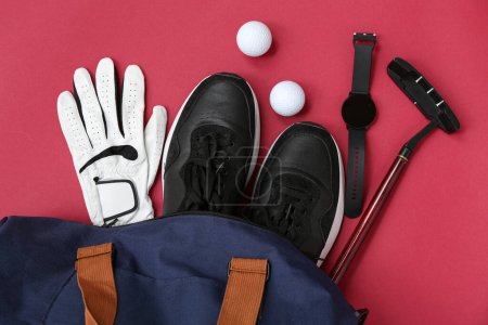Sports bag with golf equipment on red background