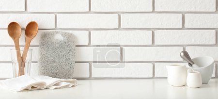 Photo for Kitchen utensils on table near white brick wall. Banner for design - Royalty Free Image