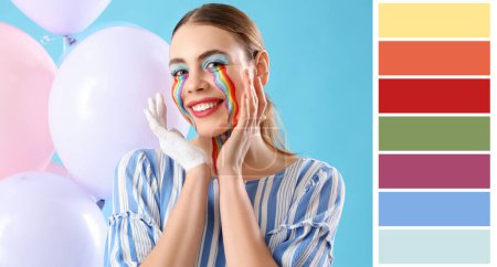 Young woman with painted rainbow on her face against blue background. Different color patterns