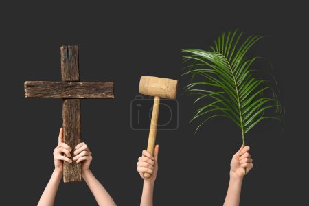 Photo for Female hands with wooden cross, mallet and palm leaf on dark background. Good Friday concept - Royalty Free Image