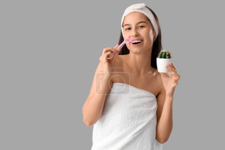 Photo for Beautiful young happy woman with razor and cactus on grey background - Royalty Free Image