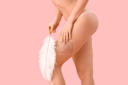 Photo for Beautiful young woman with feather after depilation on pink background, closeup - Royalty Free Image