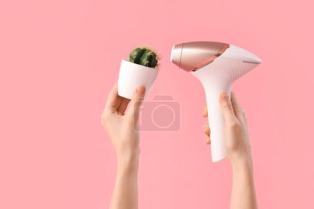 Photo for Female hands with photoepilator and cactus on pink background - Royalty Free Image