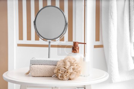 Photo for Bathing supplies and mirror on table  in bathroom - Royalty Free Image