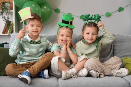 Photo for Cute kids celebrating St. Patrick's Day with festive green outfits at home party - Royalty Free Image