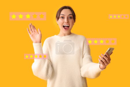 Excited woman giving rating to new mobile application on yellow background