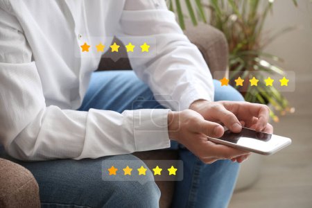 Man giving rating to new mobile application at home