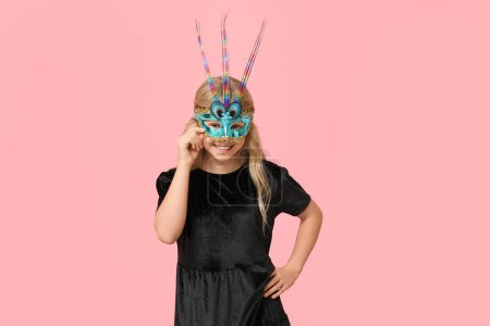 Photo for Adorable little girl wearing carnival mask on pink background - Royalty Free Image