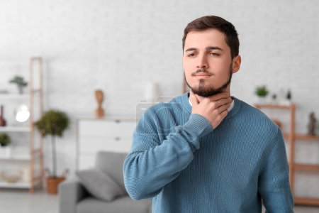 Young man with thyroid gland problem at home