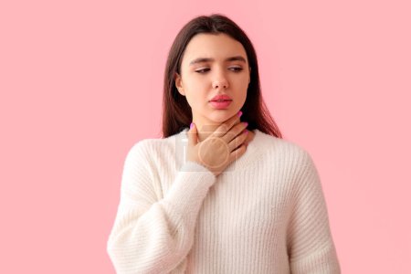 Photo for Young woman with thyroid gland problem on pink background - Royalty Free Image