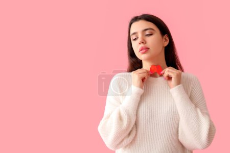 Photo for Young woman with paper thyroid gland on pink background - Royalty Free Image