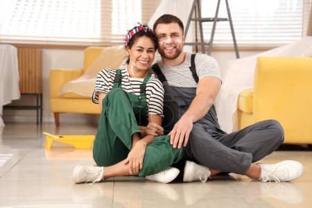 Photo for Beautiful young happy couple doing repair in new house - Royalty Free Image