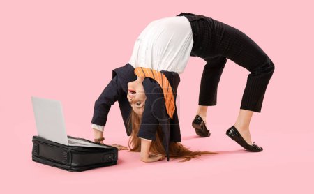 Funny businesswoman with briefcase and laptop doing exercises on pink background