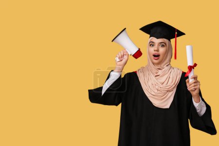 Photo for Surprised Muslim female graduating student with diploma and megaphone on yellow background - Royalty Free Image