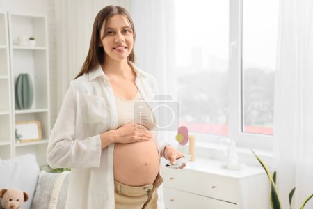 Young pregnant woman with money at home. Maternal Benefit concept