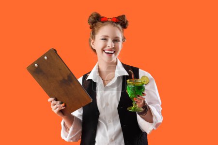 Female bartender with clipboard and cocktail on orange background