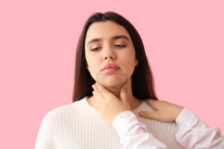 Photo for Endocrinologist examining thyroid gland of young woman on pink background - Royalty Free Image