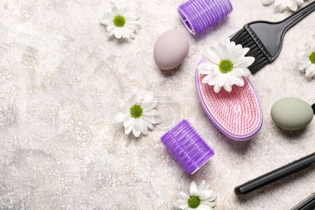 Photo for Hairdressing accessories with daisies and Easter eggs on grey grunge background - Royalty Free Image