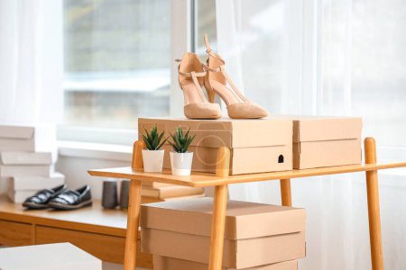 Heels with shoe boxes on shelf in shoemaker's workshop