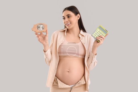 Young pregnant woman with piggy bank and calculator on light background. Maternity Benefit concept