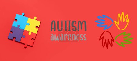 Photo for Colorful jigsaw puzzle pieces and text AUTISM AWARENESS on red background - Royalty Free Image