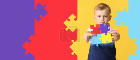Photo for Little boy with autistic disorder holding jigsaw puzzle pieces on color background with space for text - Royalty Free Image