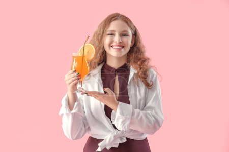 Female bartender with cocktail on pink background