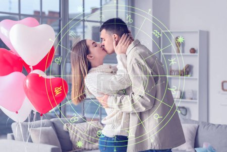 Junges Paar küsst sich zu Hause. Liebeskompatibilitätshoroskop. Partnersuche nach Geburtsdatum