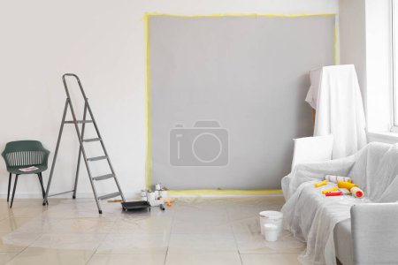 Covered furniture with repair tools in room