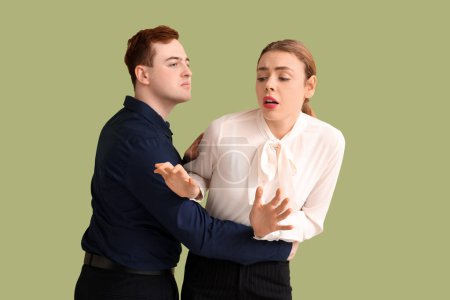 Photo for Business man molesting his female colleague on green background. Harassment concept - Royalty Free Image