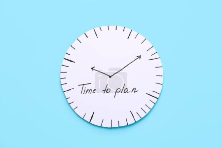 Paper clock with text TIME TO PLAN on blue background. Time management. Top view