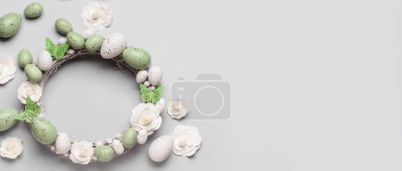 Photo for Easter wreath, flowers and eggs on light background with space for text, top view - Royalty Free Image