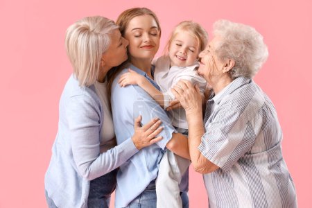 Little girl with her family hugging on pink background