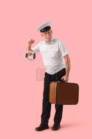 Photo for Mature sailor with bag and small ring buoy on pink background - Royalty Free Image