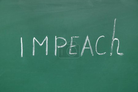 Word IMPEACH written on chalkboard
