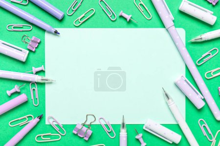 Sheet of paper with different stationery on green background. End of school. Top view