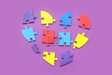 Photo for Heart made of color puzzle on purple background. Concept of autistic disorder - Royalty Free Image