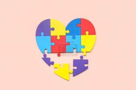 Photo for Heart made of color puzzle on beige background. Concept of autistic disorder - Royalty Free Image