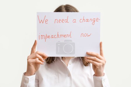 Woman holding picket poster with text WE NEED A CHANGE - IMPEACHMENT NOW on white background