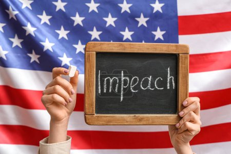 Woman holding chalkboard with word IMPEACH against USA flag