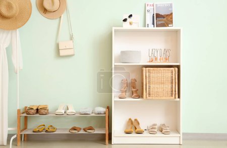 Photo for Shelf with shoes and shelving unit in room - Royalty Free Image