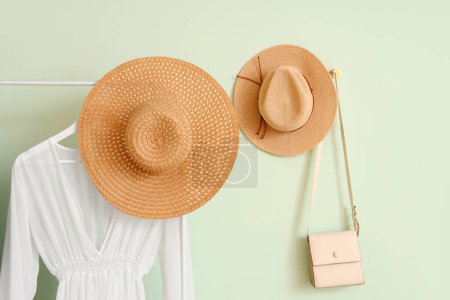 Photo for Rack with stylish set of clothes near white wall - Royalty Free Image
