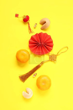 Photo for Fortune cookies with mandarins and Chinese symbols on yellow background. New Year celebration - Royalty Free Image