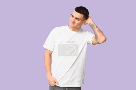 Photo for Handsome ashamed young man on lilac background - Royalty Free Image
