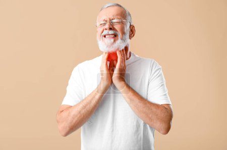 Ill mature man with sore throat on beige background