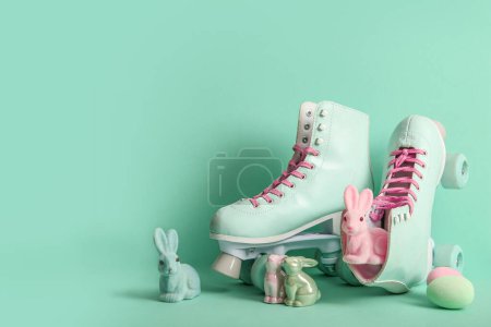 Vintage roller skates with toys bunny and Easter eggs on turquoise background