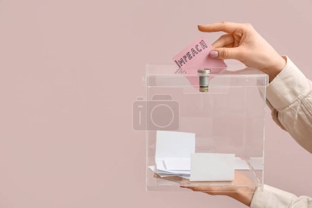 Woman putting ballot paper with word IMPEACH in voting box on pink background