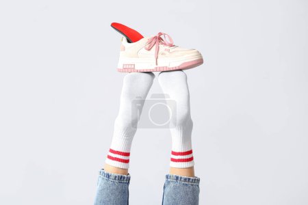 Photo for Sneakers with orthopedic insoles on female legs isolated on white background, closeup - Royalty Free Image