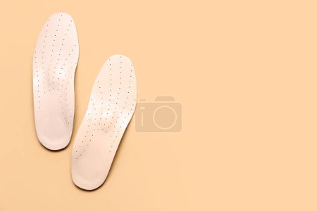 Photo for Leather orthopedic insoles on beige background - Royalty Free Image